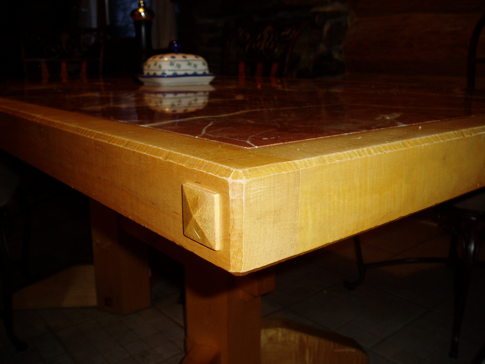Heavy dining table made of Curly Maple with marble tiled top.