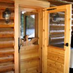 Custom built entry door with carved loon panel by John Huisman