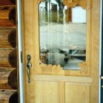 Carved maple door with Chickadees and pinecones