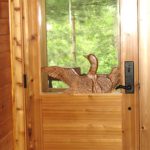 Carved loon on a cedar entry door